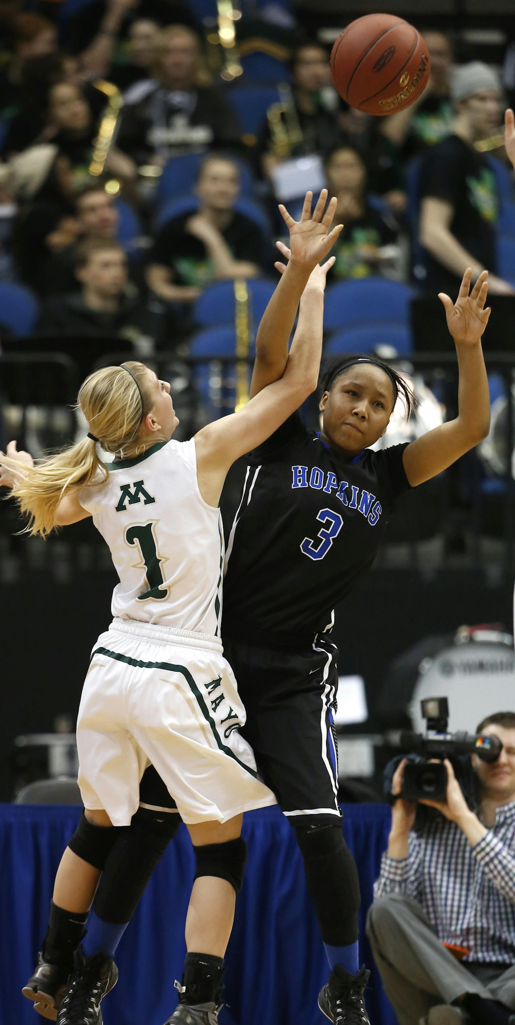Hopkins Viria Livingston made a pass up court with Rochester Mayo's Lexie Riley and Hannah Larson defending during the second half. ] (KYNDELL HARKNESS/STAR TRIBUNE) kyndell.harkness@startribune.com Hopkins vs Rochester Mayo in the quarterfinals at the Target Center in Minneapolis Min., Tuesday, March 17, 2015.Hopkins won over Rochester Mayo 62-35.