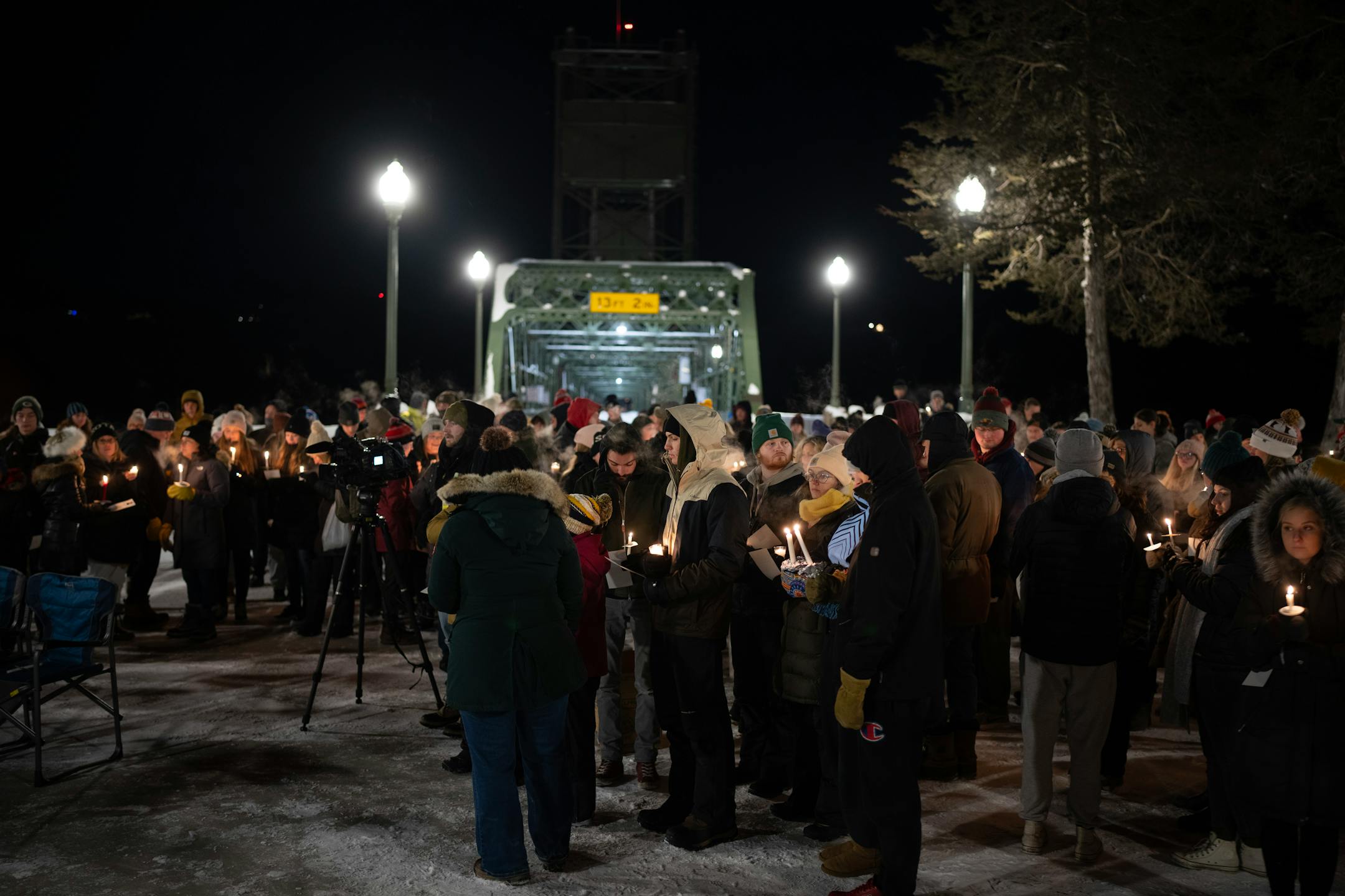 Friends and community members held candles at a vigil held Monday night, December 26, 2022 on the plaza next to the lift bridge in Stillwater to honor the memory of 20-year-old college student George Musser.