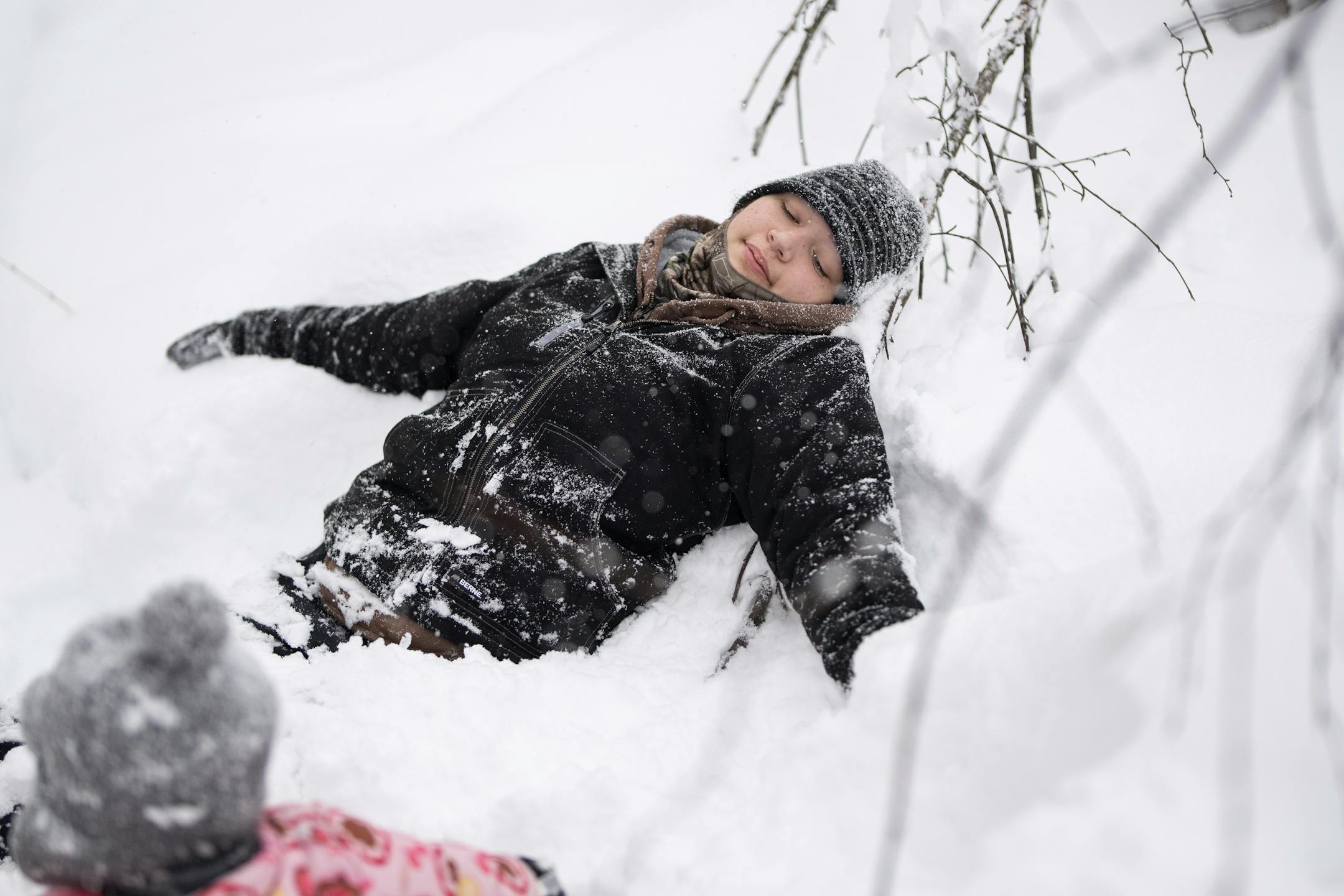 Friends, Family and Neighbor intern Niizhoodewii Denomie took a break from snowshoeing while out with a group of moms and children checking on rabbit snares.