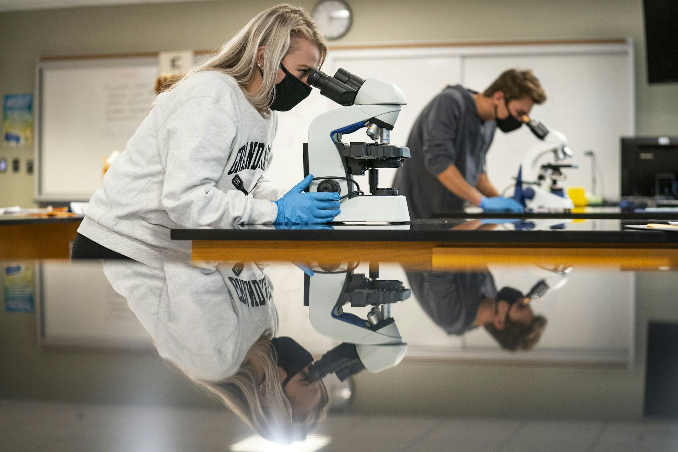 Ashley Winter, left, and Ty Karnes looked at slides through microscopes Tuesday in their anatomy and physiology 2 class at Duluth's Lake Superior College.