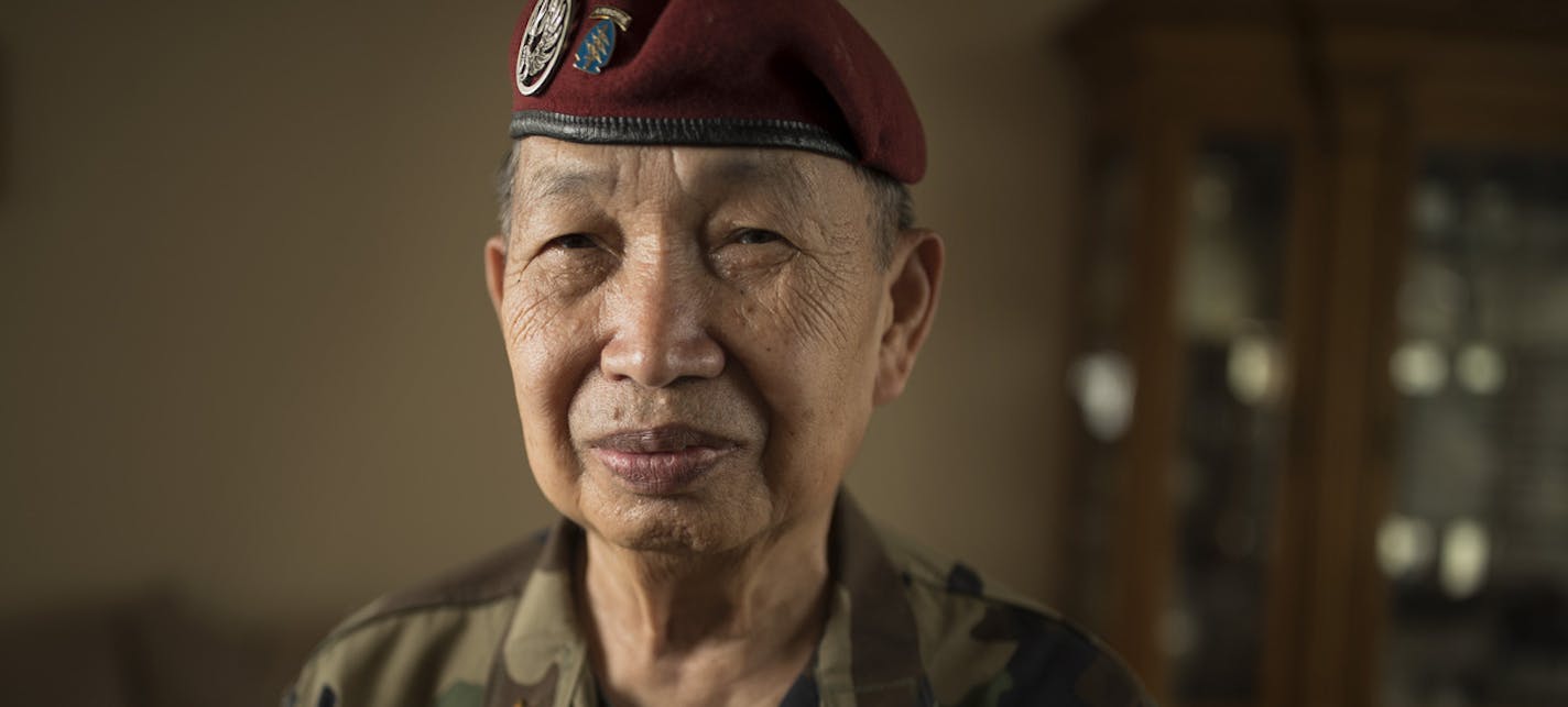 Khao Insixiengmay held a photo of himself when he was 24 years old Wednesday at his home in July 5, 2017 in Brooklyn Park, MN. Col. Insixiengmay is a veteran of the CIA's secret army in Laos during the Vietnam War. He's leading the effort of Lao Army veterans, including thousands of Hmong, to win federal recognition to qualify for burial in national cemeteries.] JERRY HOLT • jerry.holt@startribune.com