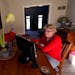 Keli Paaske searches for jobs online from the dining room of her home in Olathe, Kan. Friday, Dec. 4, 2020. Paaske was laid off in August from a compa