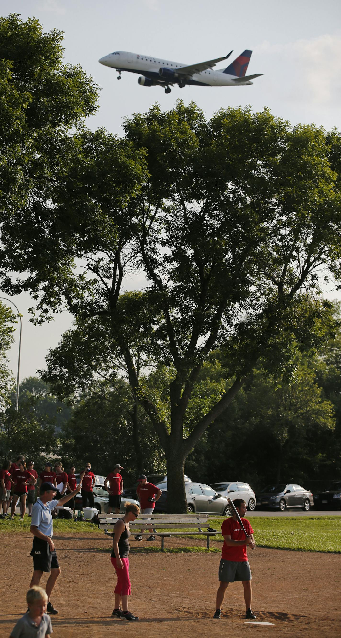 In South Minneapolis, an increase of 13% in evening plane traffic has raised the cackles of some residents. These softball players at Bossen Field Park are used to the noise .] Richard Tsong-Taatarii/rtsong-taatarii@startribune.com