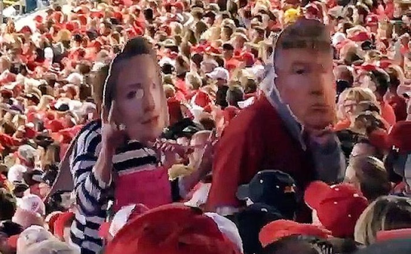 While leaving the stadium, the trailing participant in the get-up switched to a Hillary Clinton mask.