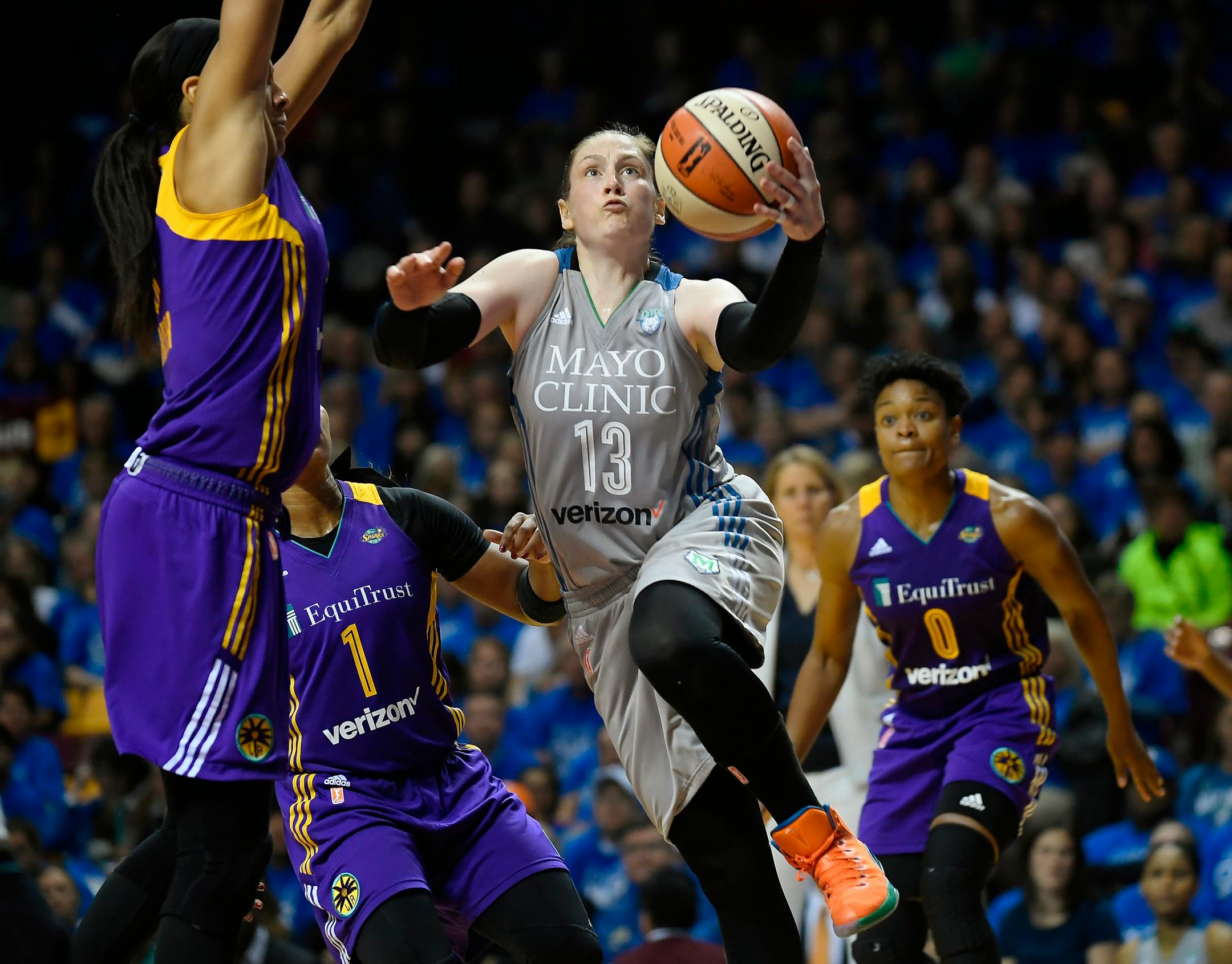 Minnesota Lynx guard Lindsay Whalen (13) scores on a layup and is fouled by Los Angeles Sparks forward Candace Parker, left, during the second half of Game 2 of the WNBA finals in Minneapolis last fall.