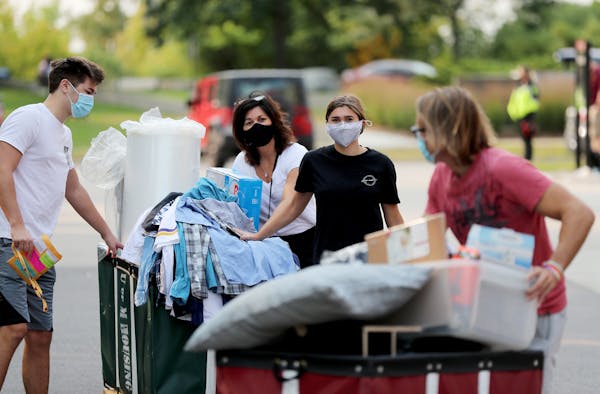 Incoming University of Minnesota freshman Sean McDonald, left to right, got help moving into his dorm room from his mom Tammi, sister Olivia, who grad