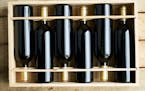 Top view of a case of cabernet sauvignon wine bottles. Wooden box with collection of six wine bottle