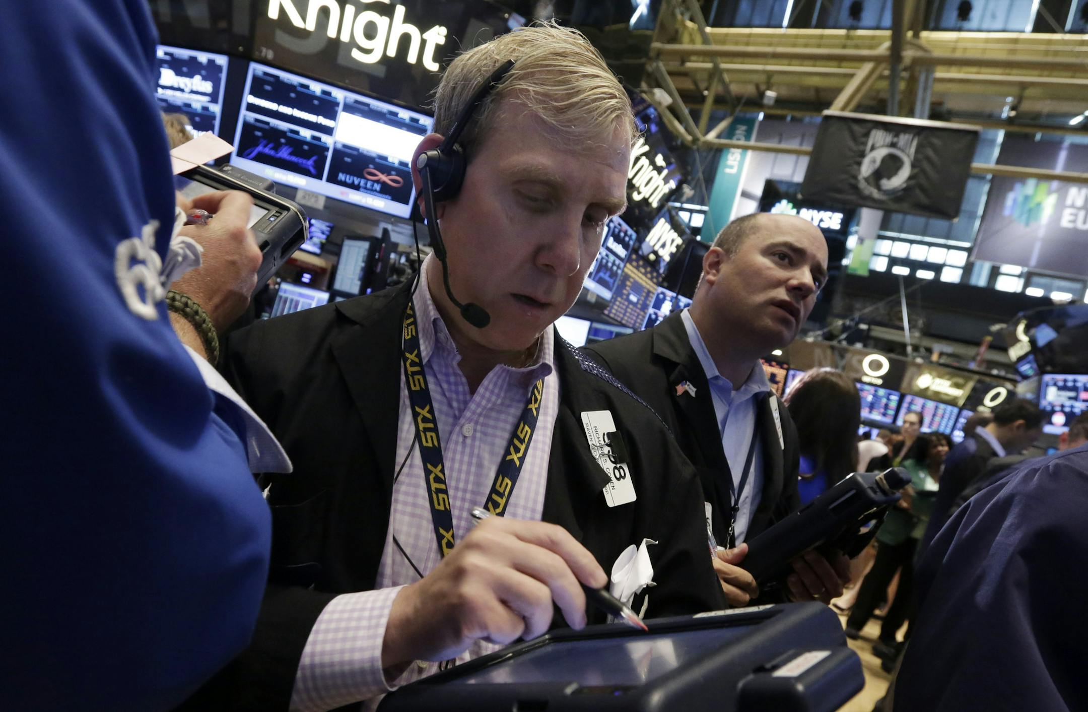 FILE - In this Friday, May 31, 2013 file photo, trader Richard Cohen, center, works on the floor of the New York Stock Exchange. Stock markets in Europe recovered their poise Thursday June 6, 2013 despite a big retreat earlier in Asia earlier and a glitch that temporarily affected several major exchanges. (AP Photo/Richard Drew, File)