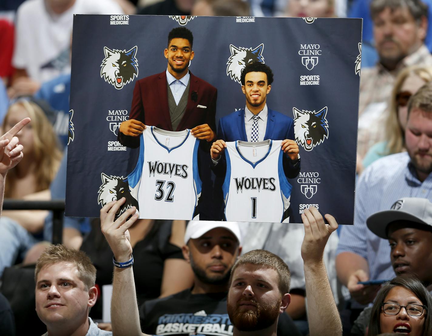 A fan held up a photo of Timberwolves first round draft picks Karl-Anthony Towns and Tyus Jones during a team scrimmage at Target Center. ] CARLOS GONZALEZ cgonzalez@startribune.com - July 8, 2015, Minneapolis, MN, Target Center, NBA, Minnesota Timberwolves, Wolves host open scrimmage