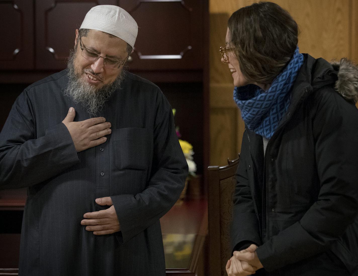 Dr. Waleed Meneese Imam of the Dar Al-Farooq Islamic Center spoke with Sarah Peters of Minneapolis during an open house at the center. ] CARLOS GONZALEZ &#xef; cgonzalez@startribune.com - Bloomington, MN - The Dar Al-Farooq Islamic Center in Bloomington, the target of an unsolved bombing last summer, is hosting an open house to show off their renovated space.