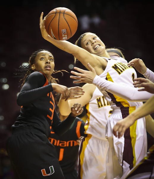 Gopher's Rachel Banham grabbed a rebound as Miami's Suriya McGuire looked on in the second half of a basketball game between the Minnesota Gophers and