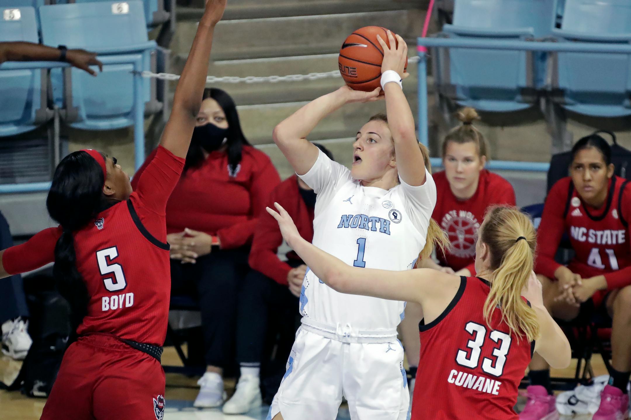 North Carolina guard Alyssa Ustby (1) shoots against North Carolina State forward Jada Boyd (5) and center Elissa Cunane (33) during the first half of an NCAA college basketball game Sunday, Jan. 30, 2022, in Chapel Hill, N.C. (AP Photo/Chris Seward)