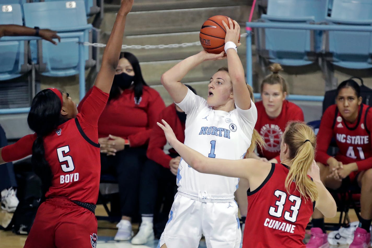 North Carolina guard Alyssa Ustby (1) shoots against North Carolina State forward Jada Boyd (5) and center Elissa Cunane (33) during the first half of an NCAA college basketball game Sunday, Jan. 30, 2022, in Chapel Hill, N.C. (AP Photo/Chris Seward)