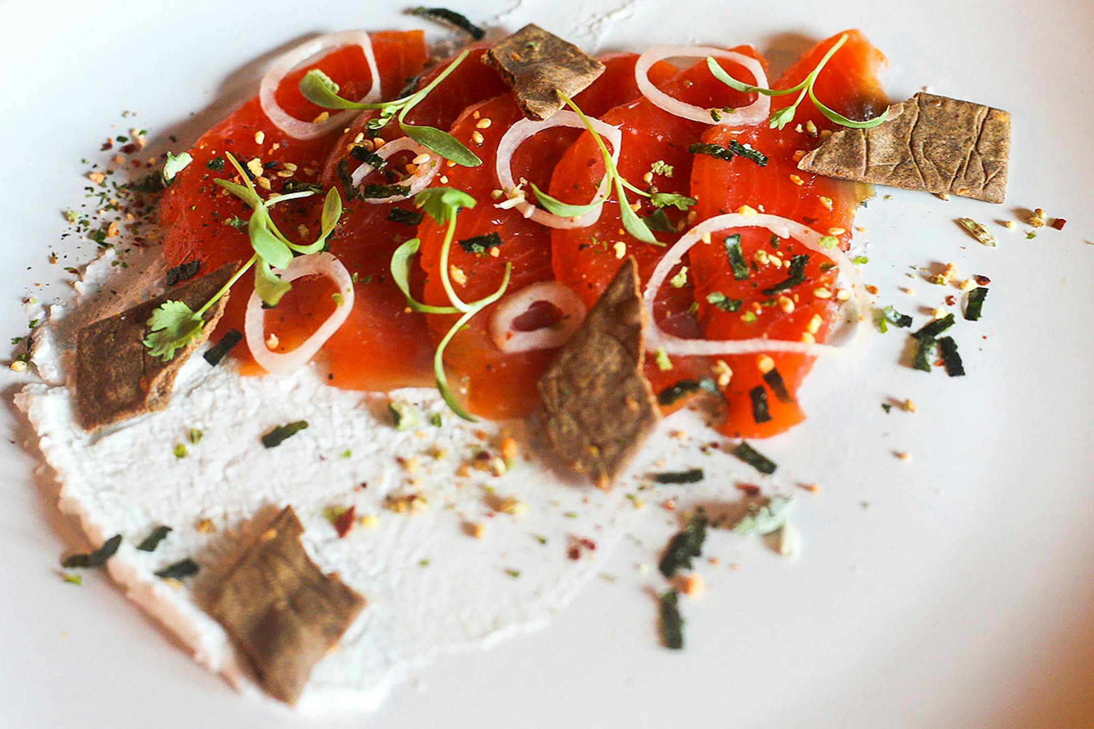 Cured sockeye salmon, cultured coconut milk, pickled shallots, fruitcake spice blend and buckwheat crackers.