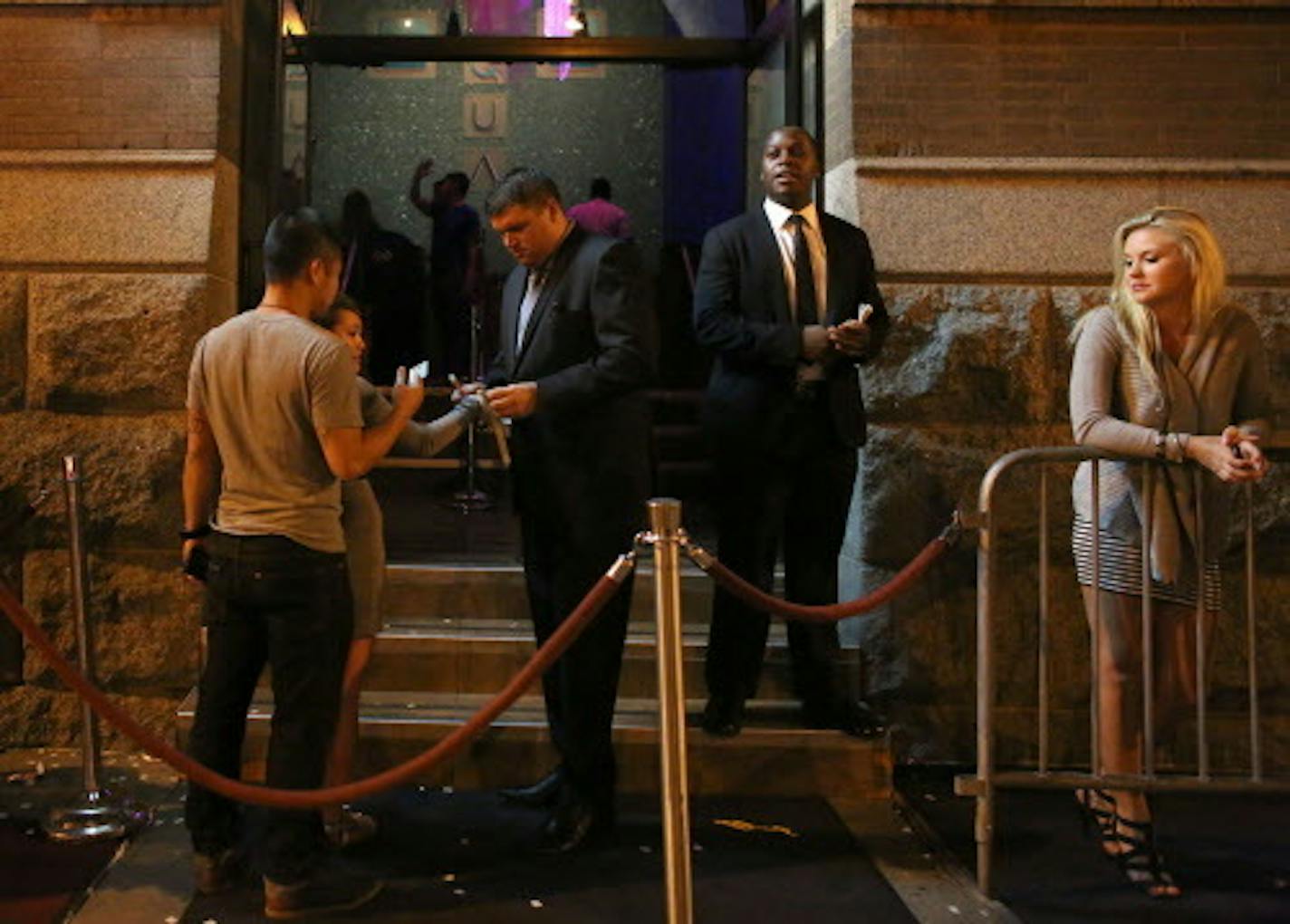 Security checked IDs at the front door of Aqua nightclub in 2014. After three were shot inside the club early Monday, Minneapolis is considering revoking the club's liquor license.