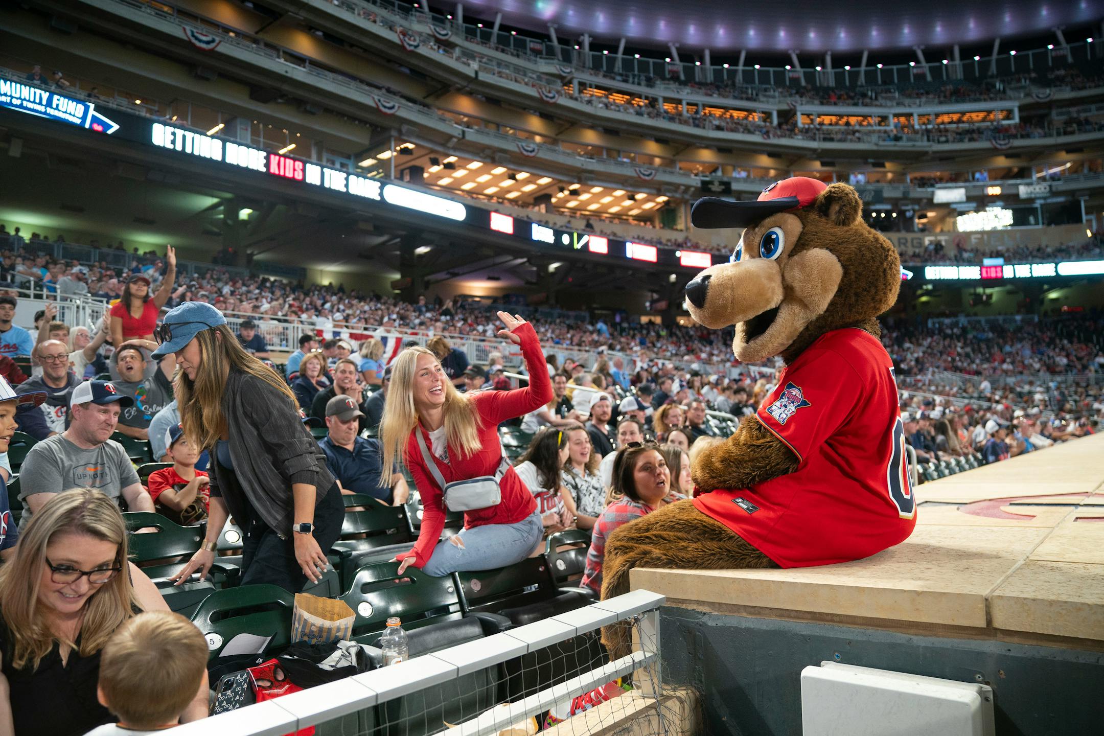 T.C. Bear, the Minnesota Twins mascot, greets fans atop the dugout in the seventh inning of their game against the Kansas City Royals Friday, May 27, 2022 at Target Field in Minneapolis. ]
