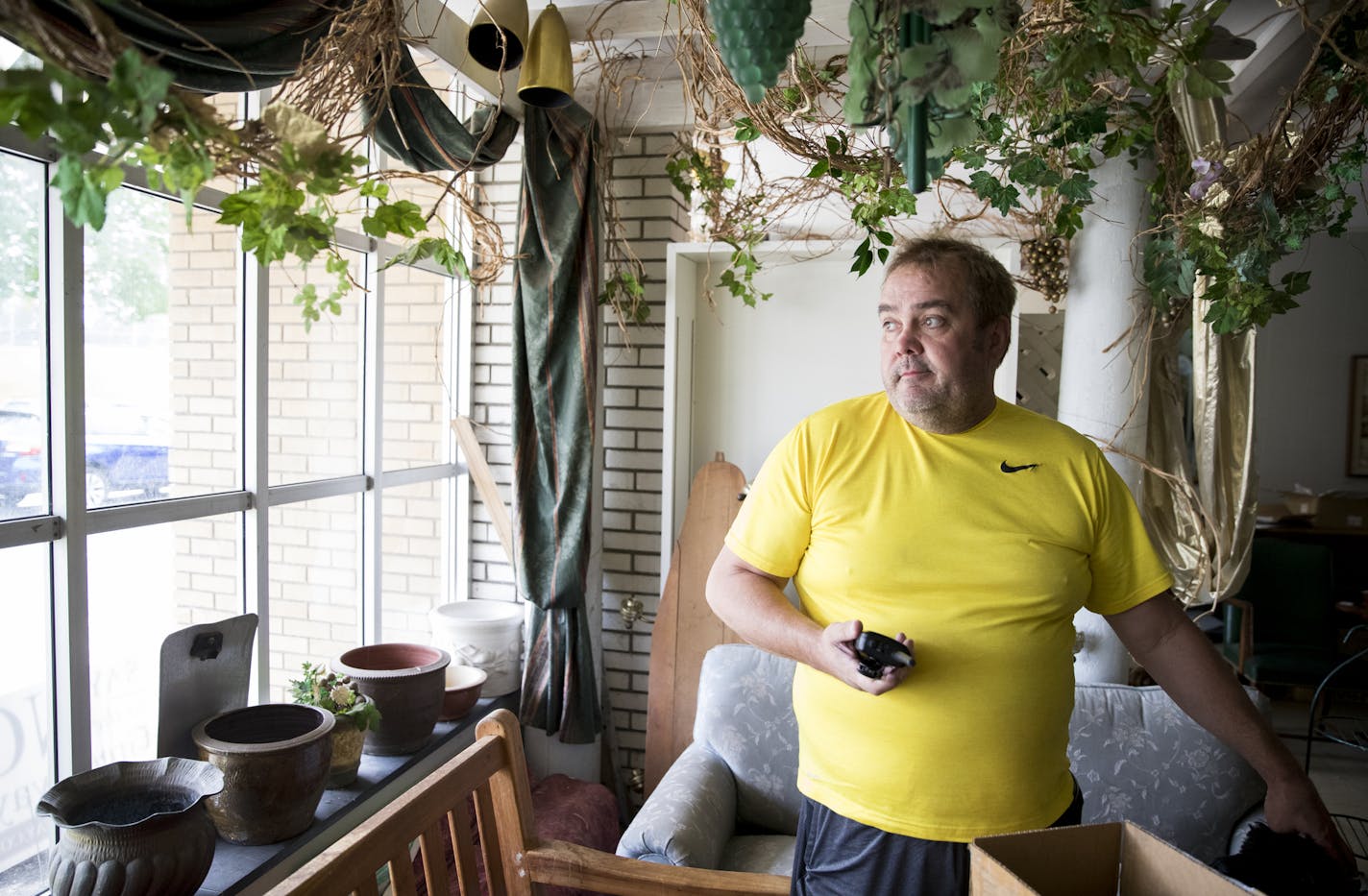 Phillip Murphy holds a scanner he keeps with him at all times including in his closed down flower shop on Dowling Avenue in north Minneapolis, Minn., on August 26, 2016. Murphy is very frustrated with the amount of gun violence in the area of his shop and keeps track of the statistics regularly. "No change can happen unless the community is aware," said Murphy about why he keeps track of the violence and posts it to social media. He closed his flower shop after vandalism and the five armed robbe