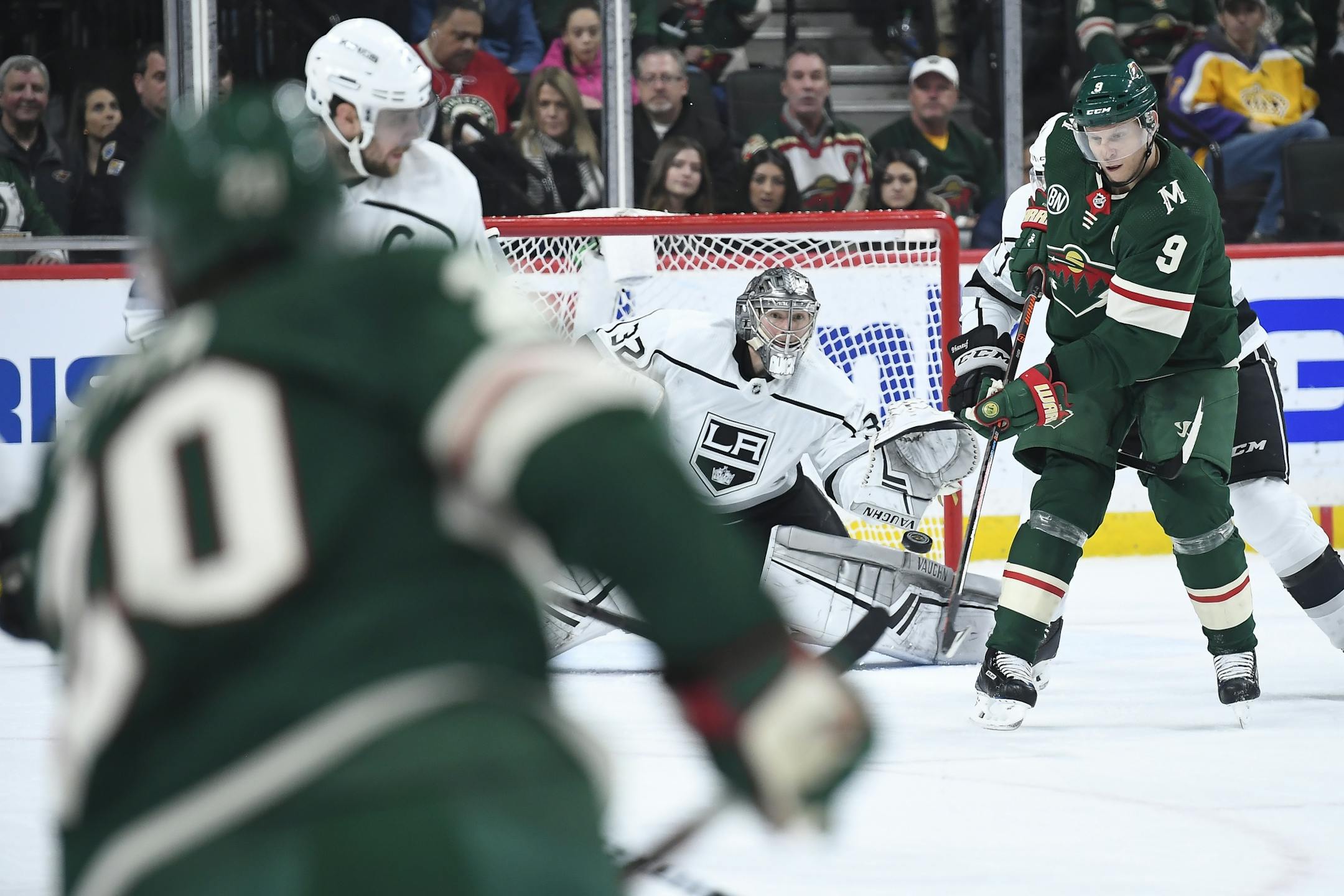 Los Angeles Kings goaltender Jonathan Quick (32) eyed a shot by Minnesota Wild defenseman Ryan Suter (20) as center Mikko Koivu (9) attempted to redirect in the second period.