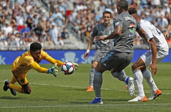 Philadelphia Union goalkeeper Andre Blake saved the ball against Minnesota United forward Angelo Rodriguez (9).