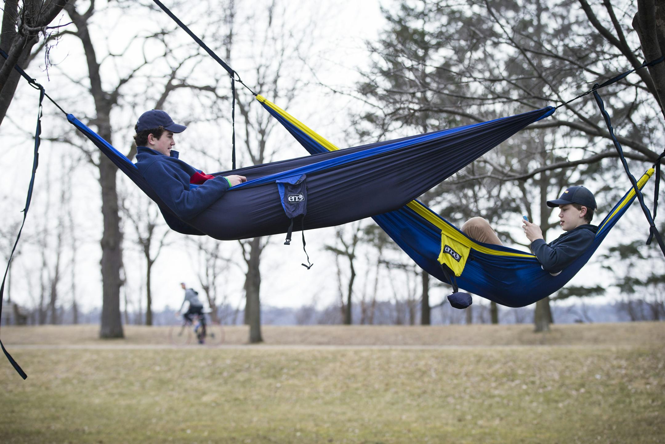 From left to right; Henry Bitter, 15 and Thor Holien, 15, chatted while hanging in their hammocks they hung at the rose garden at Lake Harriet on they're day off from school after finishing finals last week at Holy Angels, on Monday, March 7, 2016, in Minneapolis, Minn. ] RENEE JONES SCHNEIDER • reneejones@startribune.com