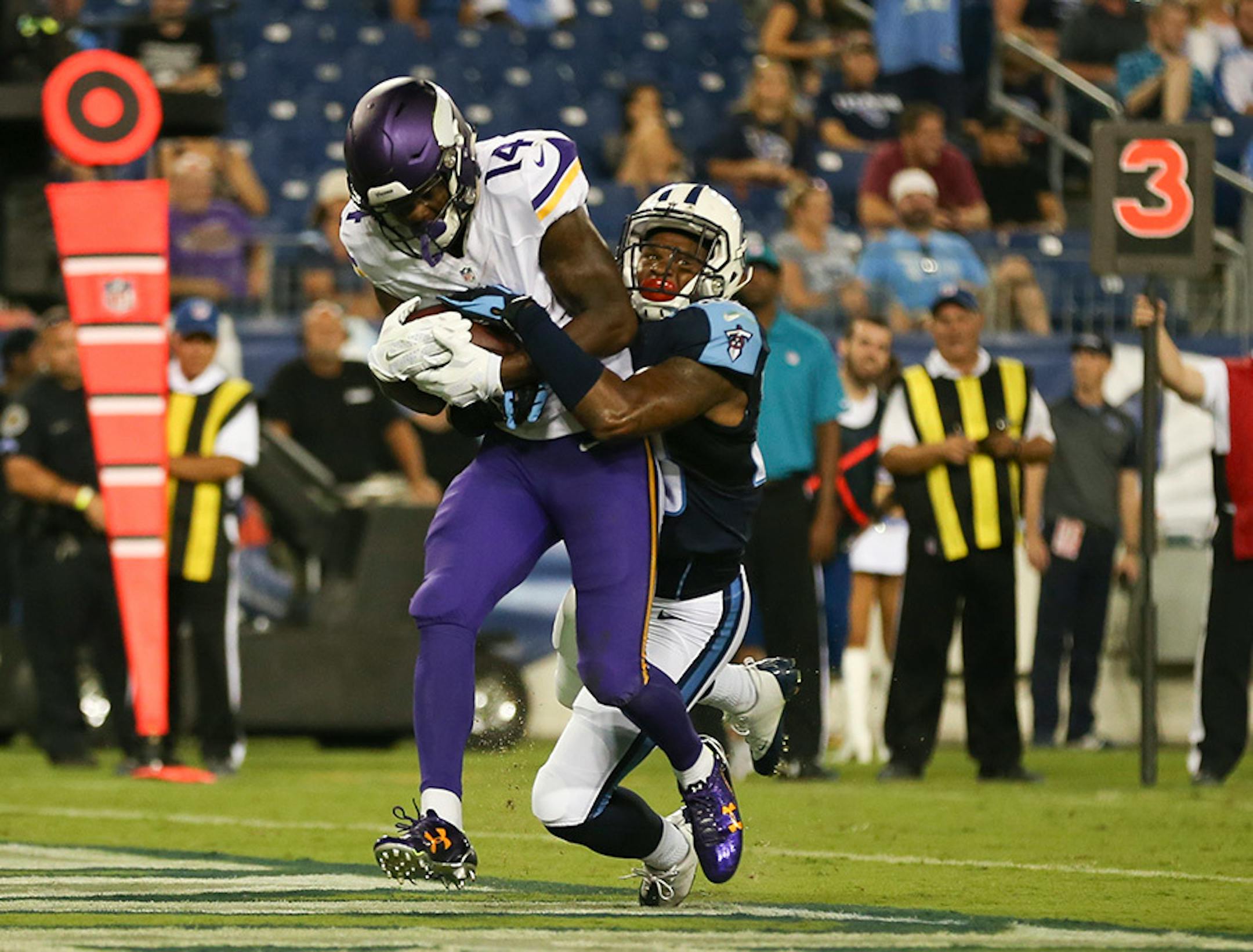 Vikings wide receiver Stefon Diggs (14) was tackled in the end zone by Titans defensive back Ri'Shard Anderson (38) after his 7 yard touchdown reception in the fourth quarter Thursday night.