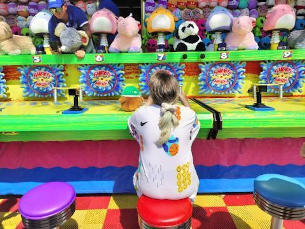 Dasha Alieksieienko, an 11-year-old from Ukraine, competed for stuffed animals at the Minnesota State Fair's Whopper Water game.
