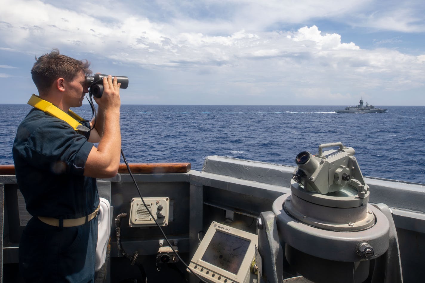 SOUTH CHINA SEA (May 20, 2022) Sa Sailor stands watch aboard the Arleigh Burke-class guided-missile destroyer USS Chung-Hoon (DDG 93) while underway with the Royal Australian Navy Anzac-class frigate HMAS Anzac (FFH 150) during surface action group operations as a part of exercise Noble Dingo. Chung-Hoon is participating in multilateral exercises in the South China Sea with the Royal Australian Navy. Multi-later exercises like this reassure our allies and partners of the U.S. commitment to maintaining a free and open Indo-Pacific. (U.S. Navy photo by Mass Communication Specialist 1st Class Andre T. Richard)