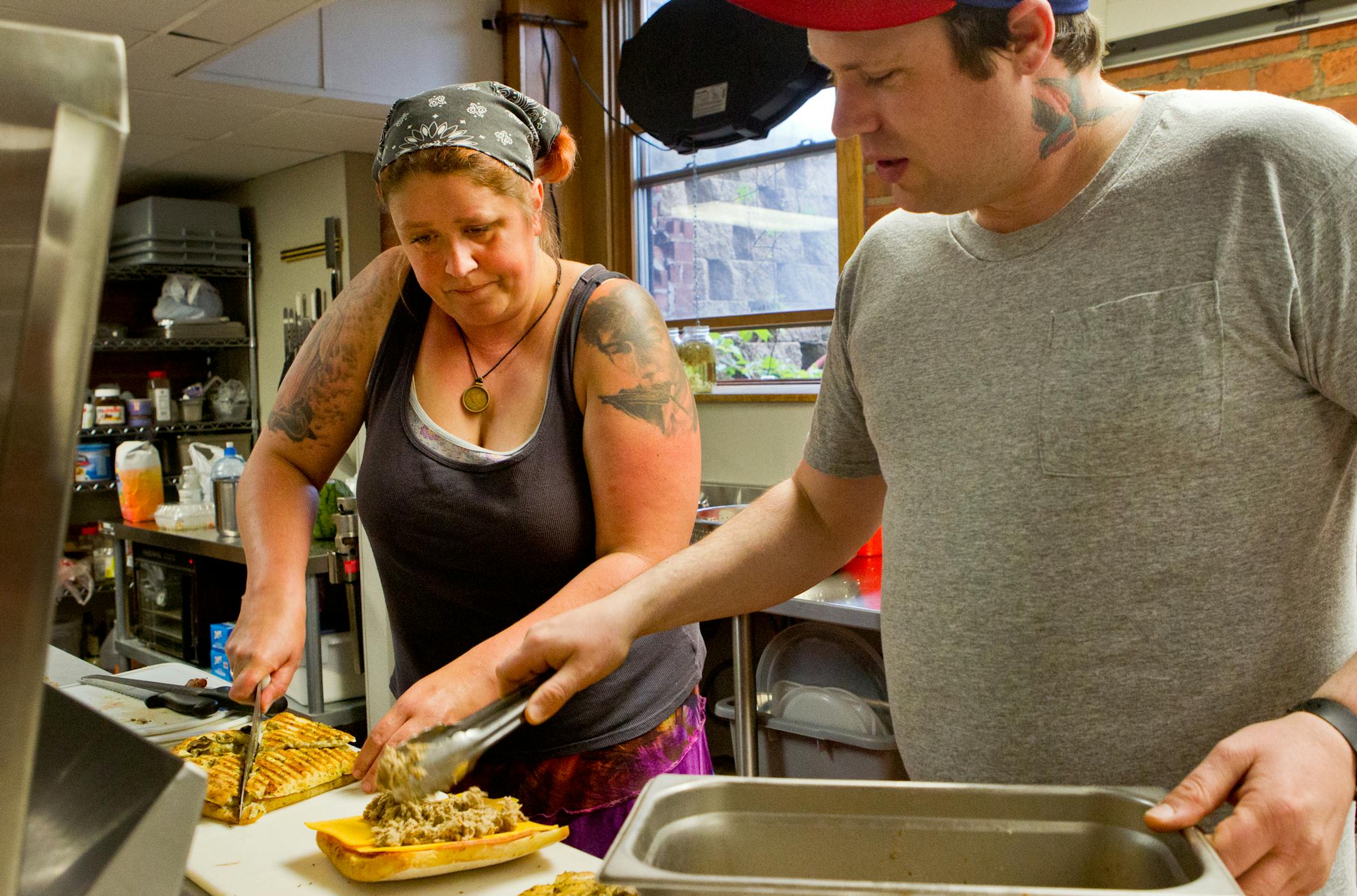 Koli Fyten-Swap (left) and her brother-in-law, Nate Swap, prepare sandwiches at Jellybean and Julia's deli in Anoka, Minn., on Wednesday, June 4, 2013. Her and her husband, Cory Swap, started a food truck business a year ago and opened the indoor shop on Friday, May 31, 2013. They make everything from scratch, including the homemade mustards, jams and sauces. ] (ANNA REED/STAR TRIBUNE) anna.reed@startribune.com