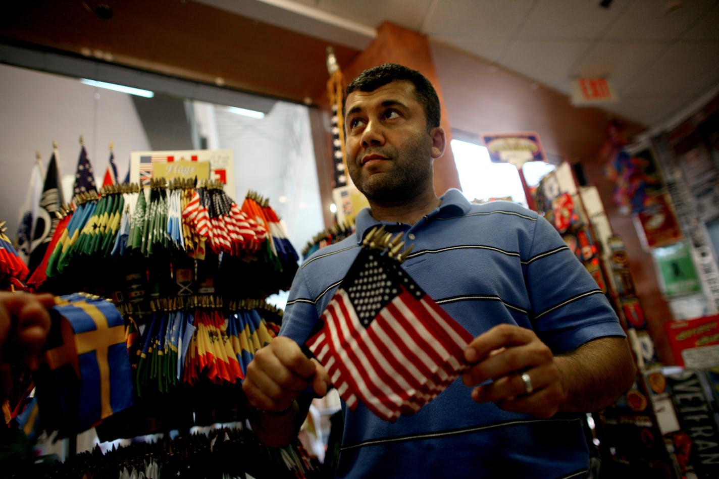 Imad Ardah, co-owner of Alamo Flags in the Mall of America, gathered small versions of Old Glory for a customer Wednesday. "One of my American flags that costs $39 used to cost just $19," Ardah said.