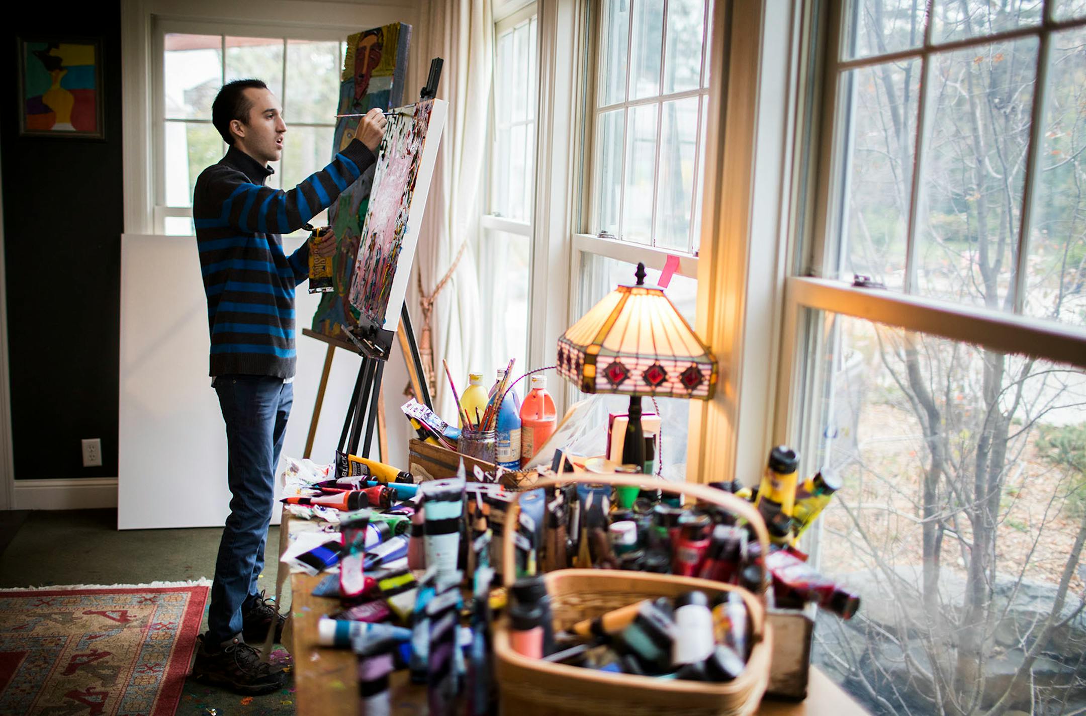 Jimmy Reagan paints inside his home studio.
