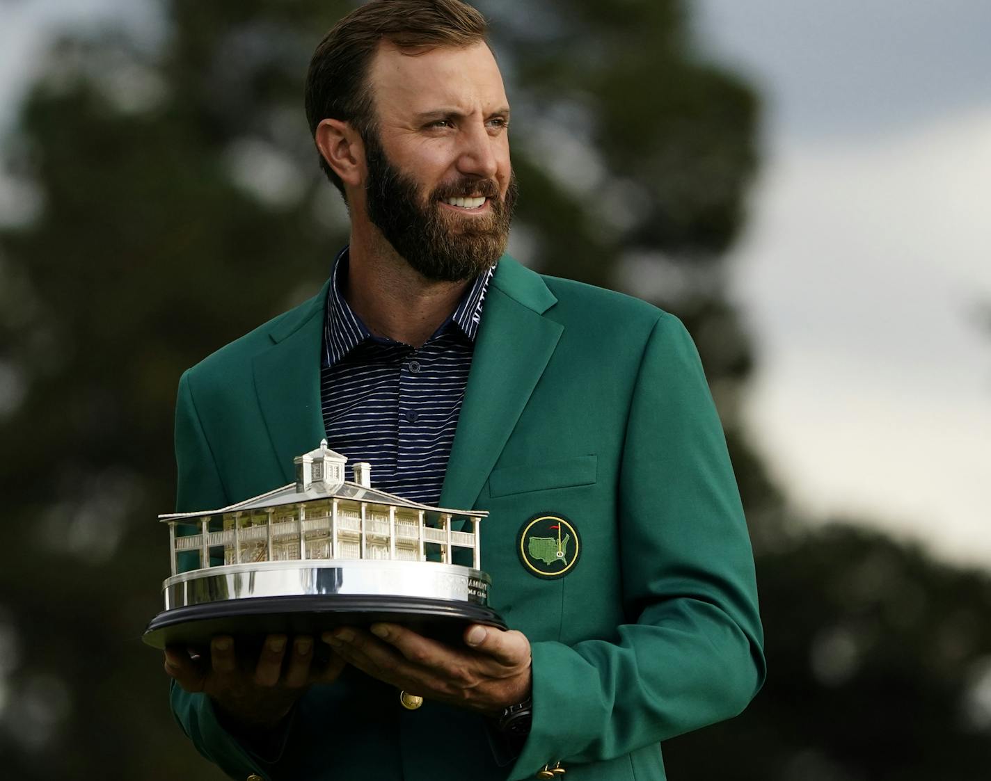 Masters golf champion Dustin Johnson holds the tournament trophy after his victory Sunday, Nov. 15, 2020, in Augusta, Ga. (AP Photo/Matt Slocum)