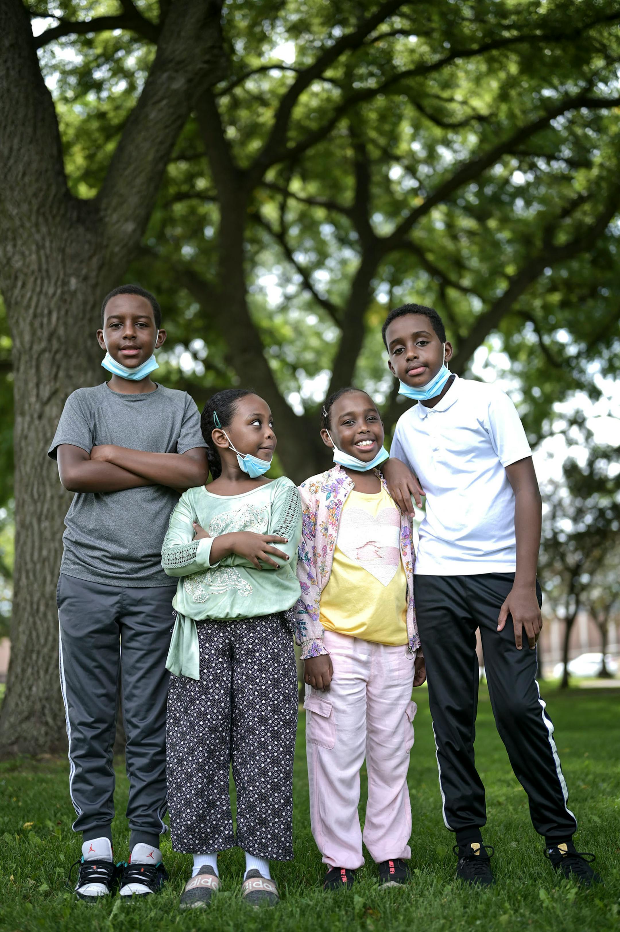 From left, siblings Jama, 14, Janna, 7, Jamila, 9, and Jibrirl, 12, stood for a portrait at Murphy Square in Minneapolis Sunday. Janna, the youngest, says she's afraid of getting sick from the coronavirus and losing her sense of taste. Her family has been diligent about staying isolated so she says she misses her friends and can't wait to see them when the pandemic is over. Jama says life has been difficult, not being able to see family and friends and shift to online learning. Jama is aware of