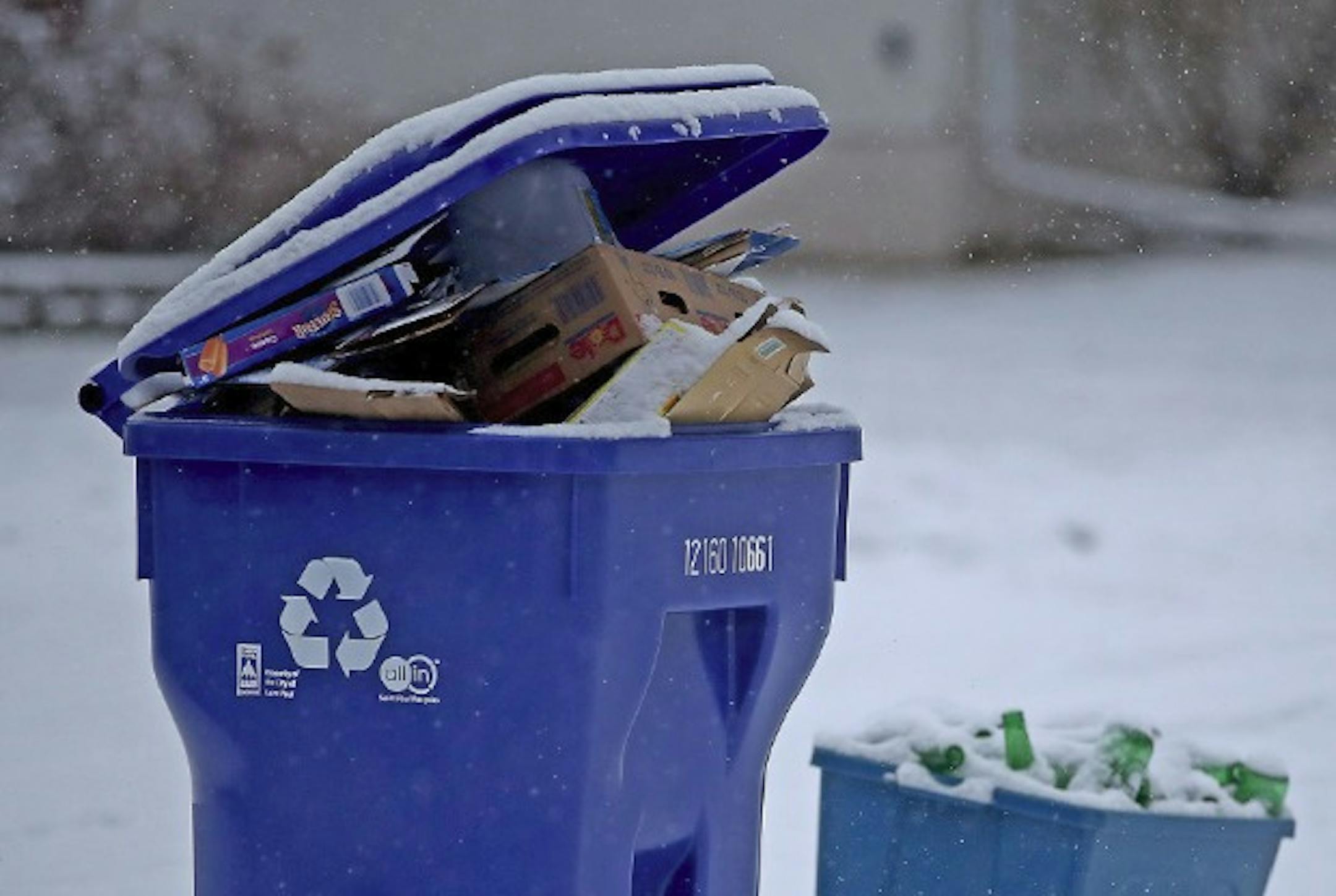 A recycling bin is filled to the rim as it sits on a street Jan. 25, 2017, in St. Paul.