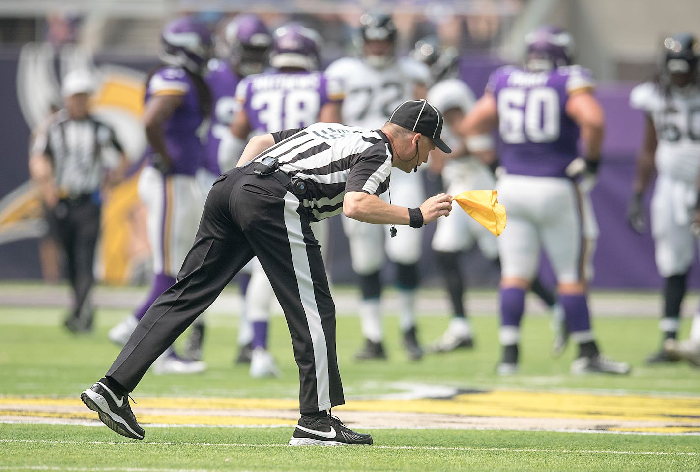 Back Judge Rich Martinez picked up one of the many penalty flags thrown as the Vikings took on the Jaguars in a preseason game.