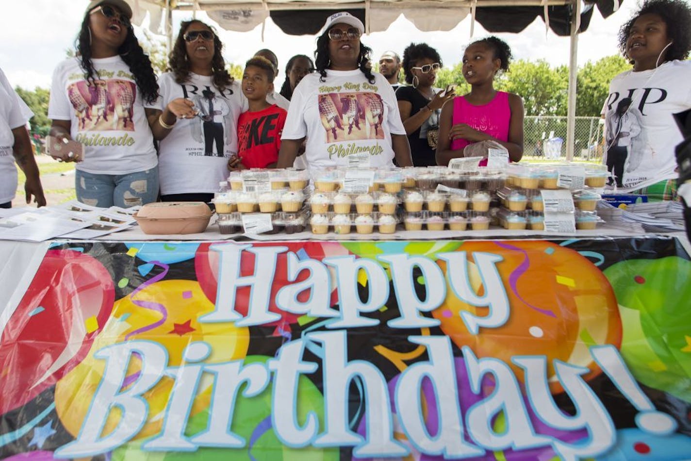 Valerie Castile, Philando Castile's mother, white hat, and Allysza Castile, khaki hat, sang happy birthday with family and friends to celebrate Philando's 33rd birthday.