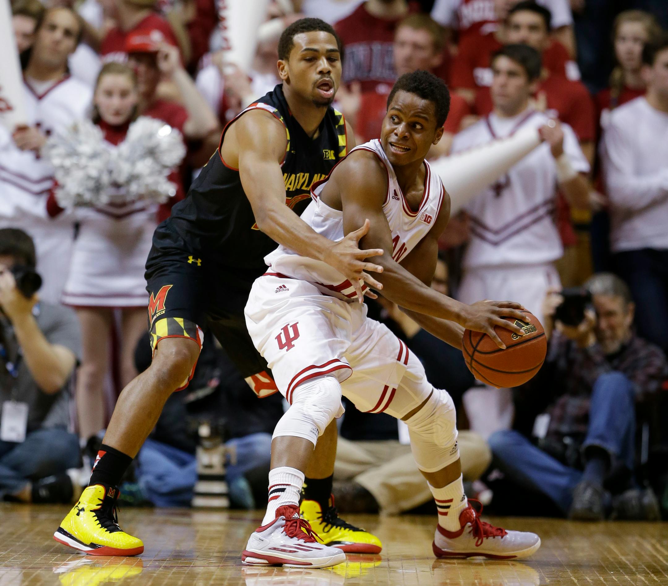 Maryland guard Richaud Pack (20), left, tries to trap Indiana guard Yogi Ferrell (11) in the first half of an NCAA college basketball game in Bloomington, Ind., Thursday, Jan. 22, 2015. (AP Photo/Michael Conroy)