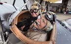 "I love flying," said 94-year-old Donal L. Russell, who sat with his son Donal S. Russell, 69, in the front seat of a 1929 biplane before a flight in 