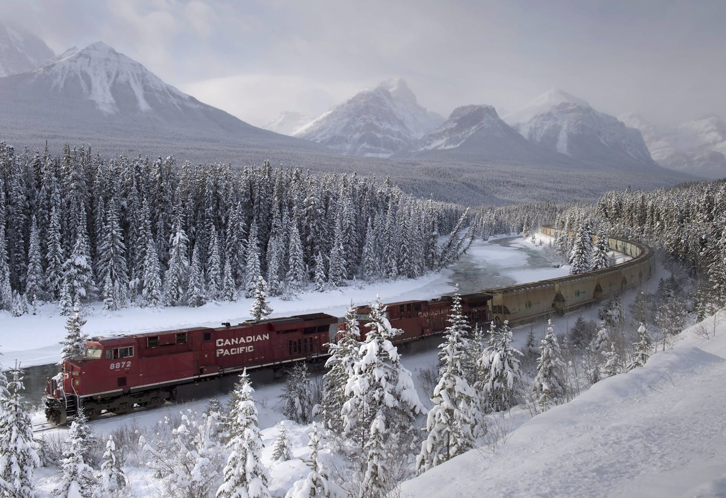 FILE - In this Dec. 1, 2014, file photo, a Canadian Pacific freight train travels around Morant's Curve near Baker Creek, Alberta. Canadian Pacific said Monday, April 11, 2016, it is ending its nearly $30 billion takeover bid for Norfolk Southern. (Frank Gunn/The Canadian Press via AP, File) MANDATORY CREDIT