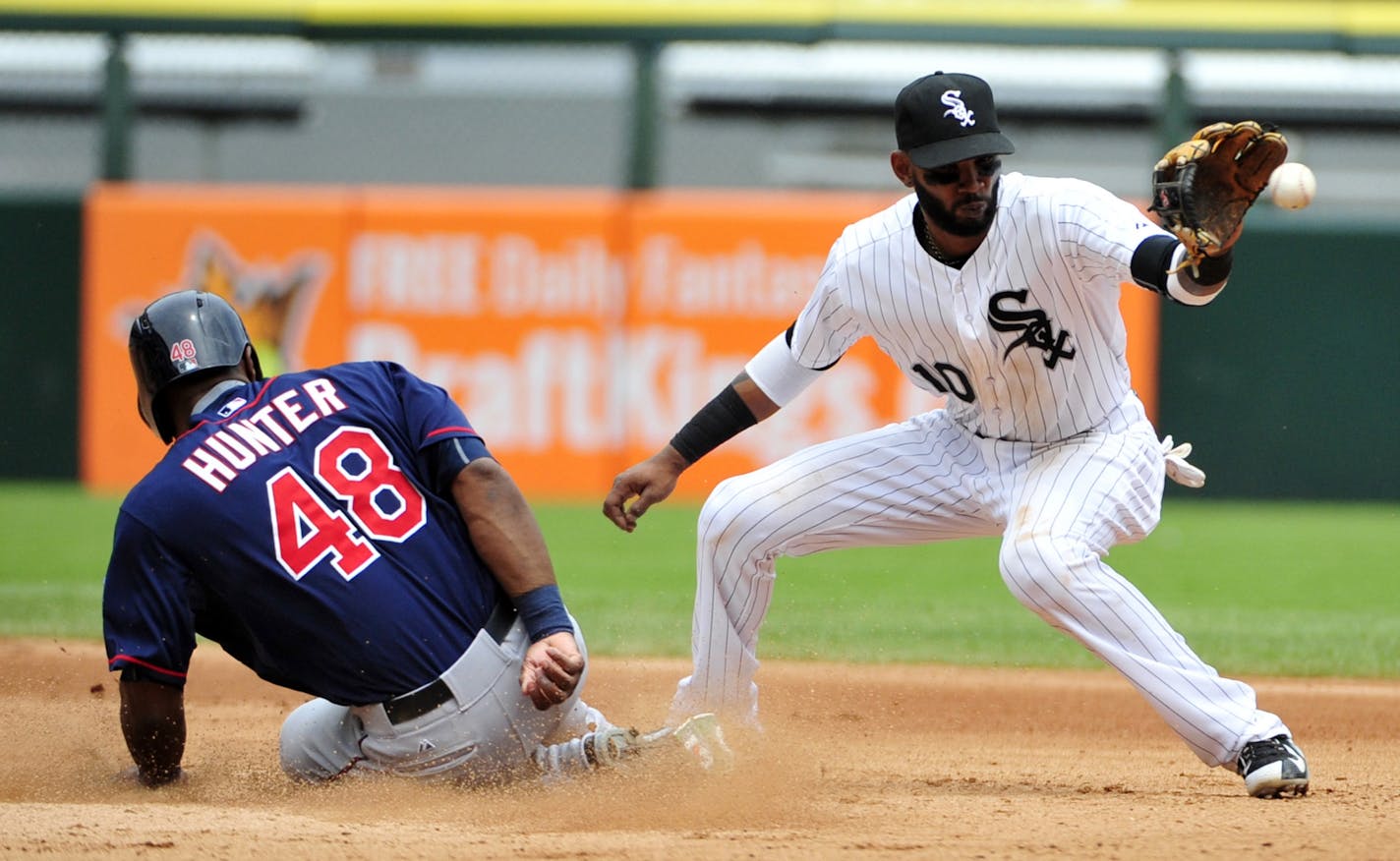 Minnesota Twins' Torii Hunter (48) is safe at second base as Chicago White Sox shortstop Alexei Ramirez (10) takes the throw during the fourth inning of a baseball game, Sunday, May 24, 2015, in Chicago.