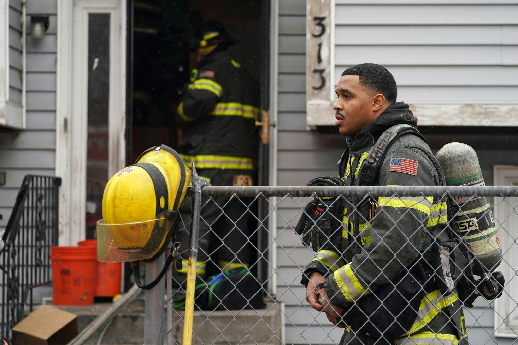 A Minneapolis fire fighter shed some of his gear for another sweep inside after fighting a house fire Tuesday afternoon in Northeast Minneapolis. ] ANTHONY SOUFFLE • anthony.souffle@startribune.com
