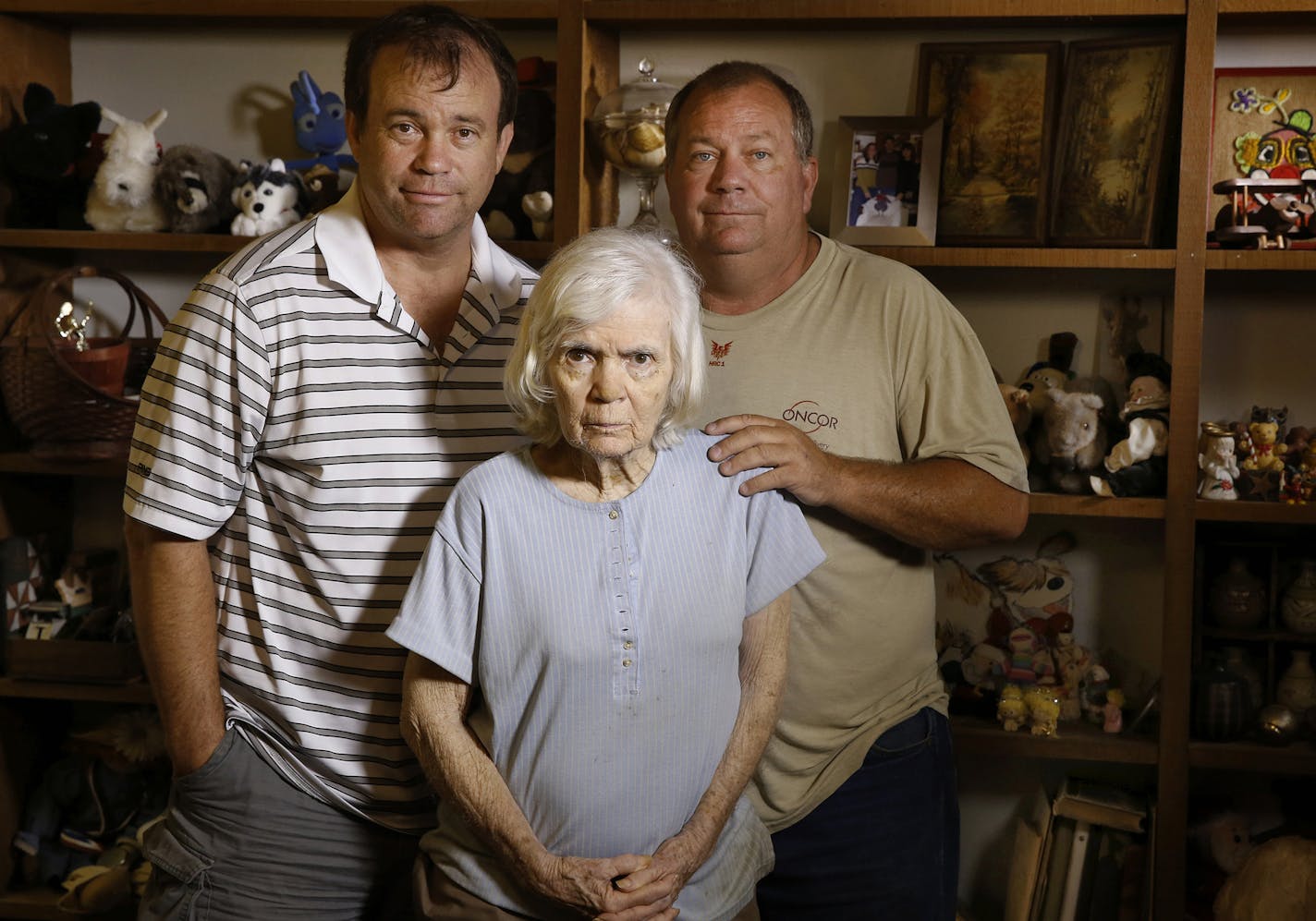 Kent, left, and Mark Olds stand with their mother Gail, 80, in Gail's Dallas home on Thursday, June 11, 2015. Gail has dementia but denies it. Her sons have to pay her bills and help her with some of her daily tasks. (David Woo/Dallas Morning News/TNS) ORG XMIT: 1169762