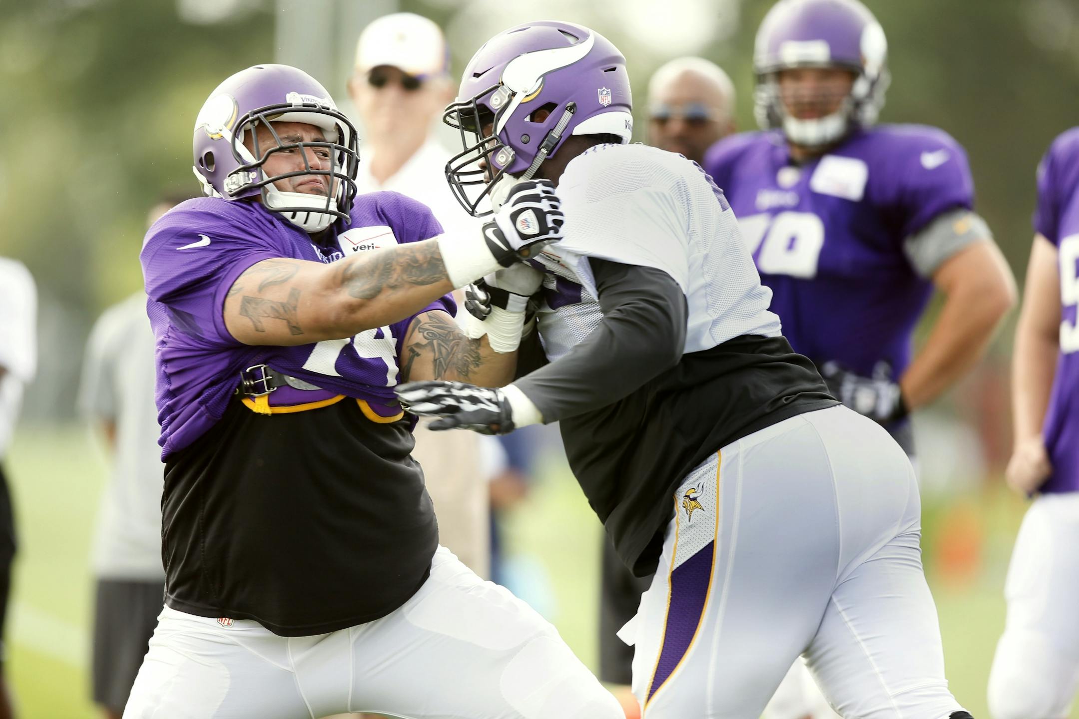 Sharrif Floyd right pushed Charlie Johnson backwards during NFL camp at Minnesota State University , Mankato Wednesday July 30, 2014 in Mankato, MN .