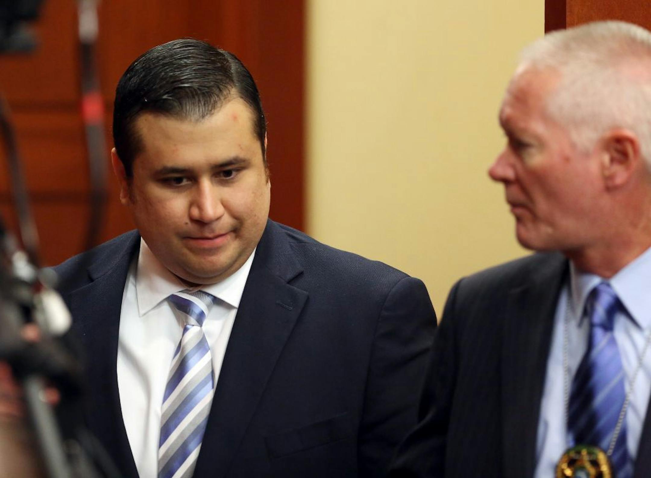 George Zimmerman, left, enters the courtroom for the start of day 13 of his trial in Seminole circuit court in Sanford, Fla. Wednesday, June 26, 2013. Zimmerman has been charged with second-degree murder for the 2012 shooting death of Trayvon Martin.