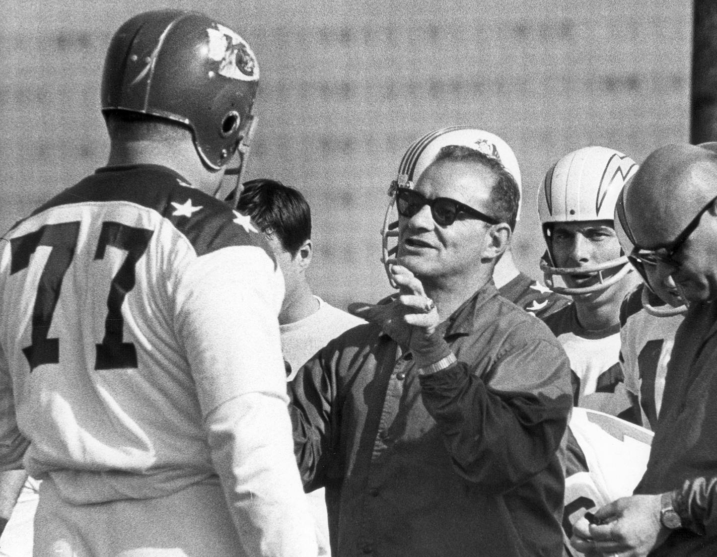 AFL all-star coach coach Sid Gillman, center, directs Kansas City Chiefs tackle Jim Tyrer