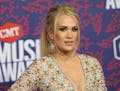 FILE- In this June 6, 2019 file photo, Carrie Underwood arrives at the CMT Music Awards at the Bridgestone Arena in Nashville, Tenn. On Wednesday, Jun