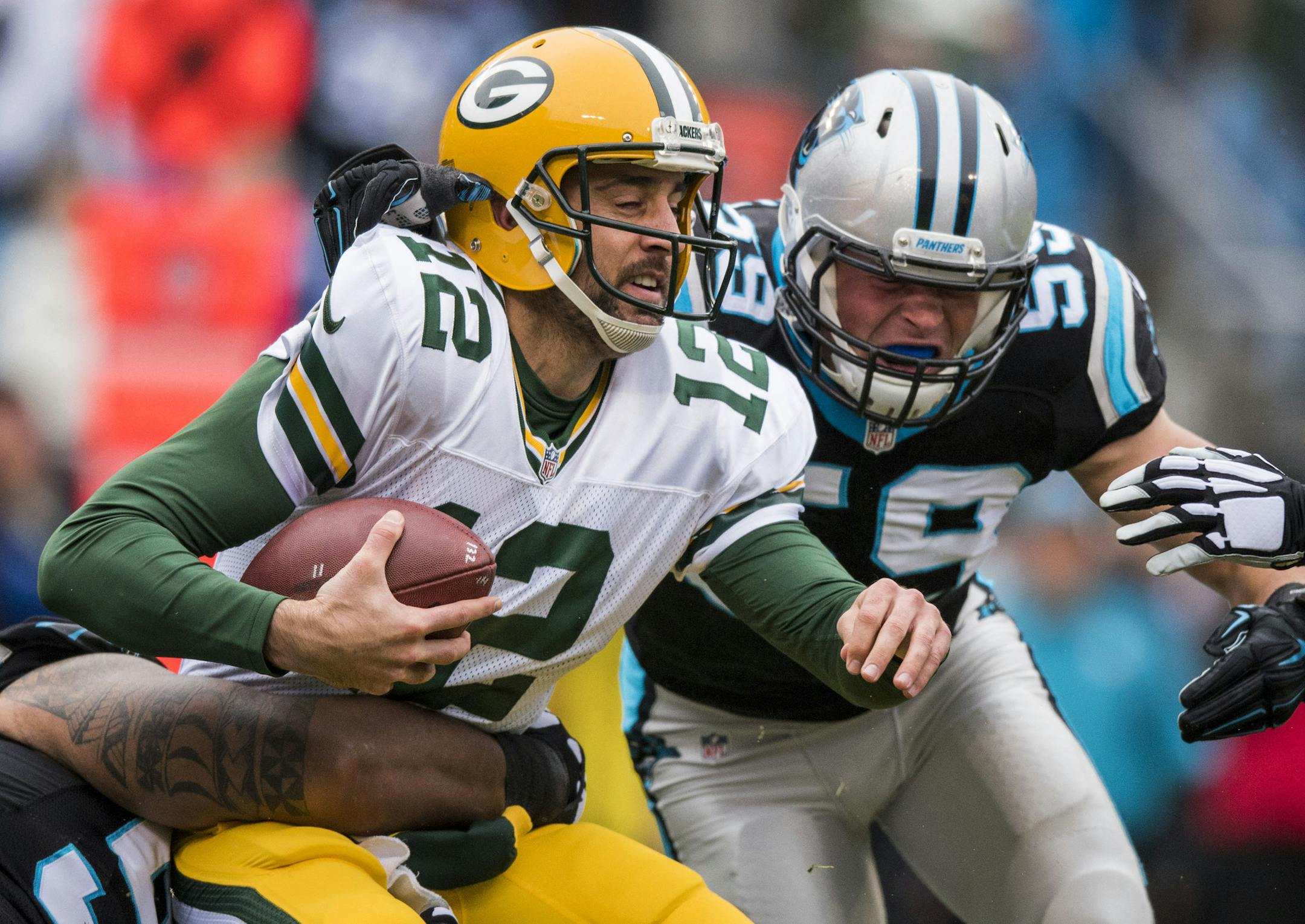 Green Bay Packers quarterback Aaron Rodgers (12) is sacked by Carolina Panthers defensive tackle Star Lotulelei (98) and Carolina Panthers linebacker Luke Kuechly (59) during the NFL football game between the Green Bay Packers and the Carolina Panthers on Sunday, Nov. 8, 2015 in Charlotte, NC. Jacob Kupferman/CSM (Cal Sport Media via AP Images) ORG XMIT: CSMAP