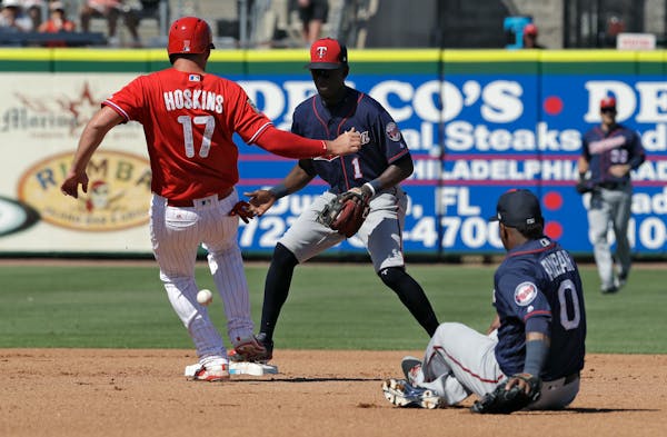 The Phillies' Rhys Hoskins was safe at second base as Twins second baseman Erick Aybar made an error on a relay throw to shortstop Nick Gordon during 