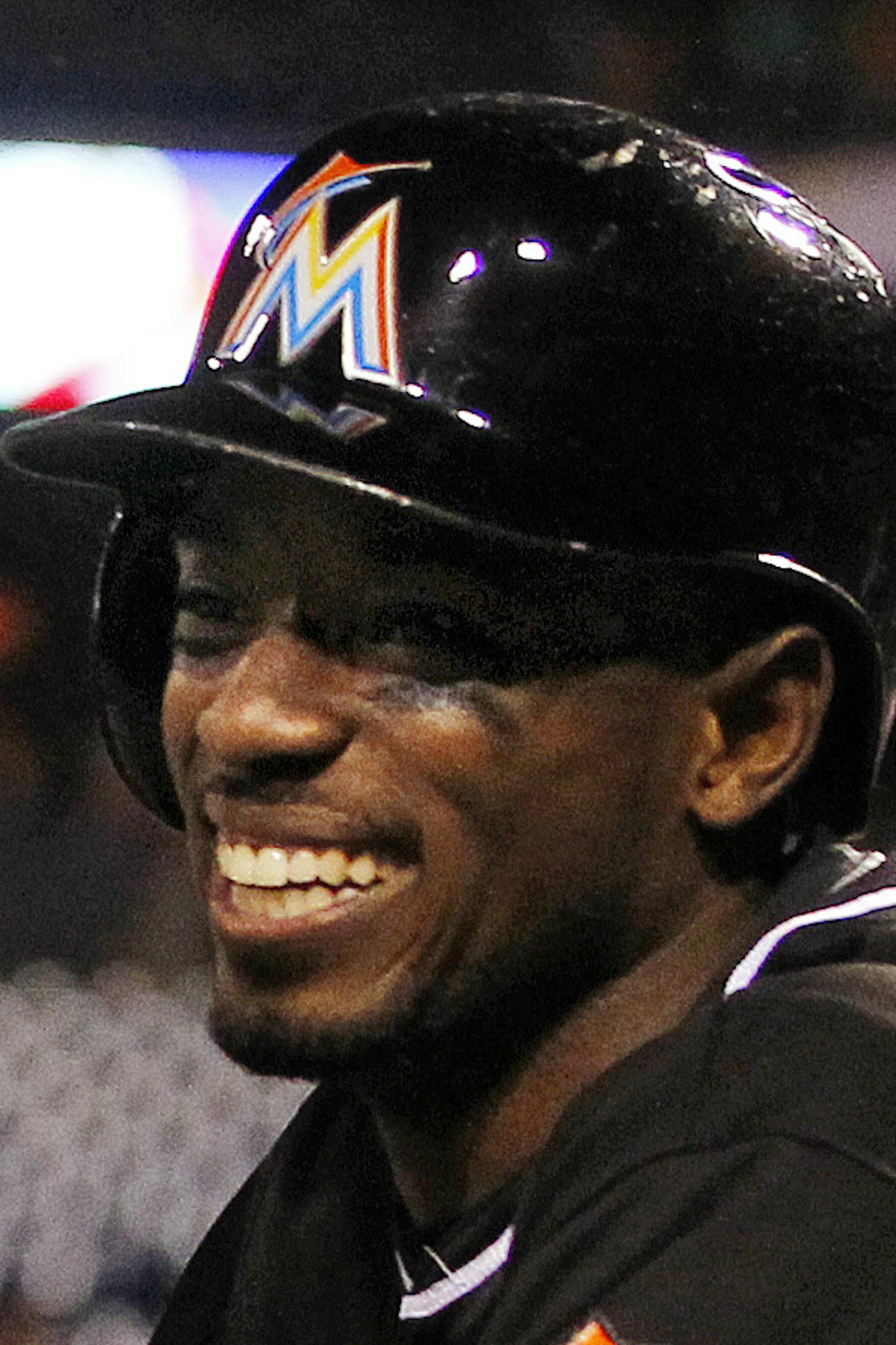Miami Marlins' Christian Yelich, left, and Dee Gordon smile after they scored on Justin Bour's two-run double against the Philadelphia Phillies during the first inning of the second game of a baseball doubleheader Saturday, Oct. 3, 2015, in Philadelphia. (AP Photo/Rich Schultz) ORG XMIT: MIN2015100423014574
