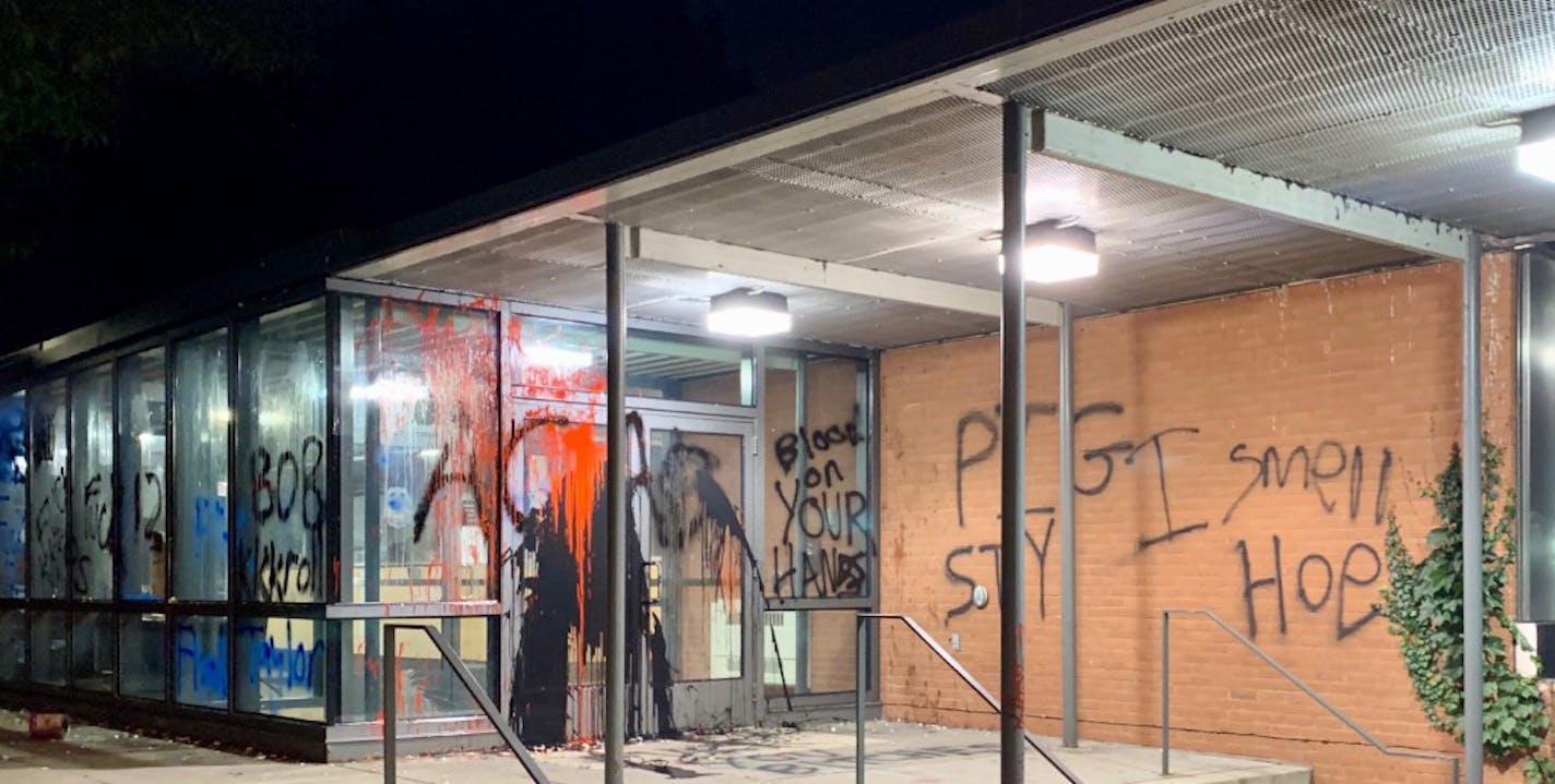 Protesters covered the 5th Precinct's headquarters with graffiti and broke a window with rocks on Saturday night, after what began as a peaceful march.