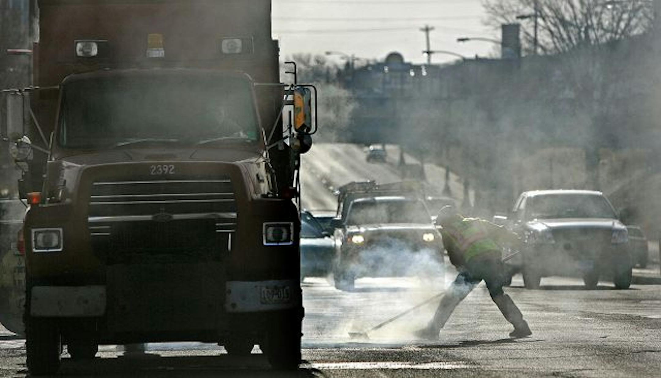 Mild weather and sunshine made the work a little less arduous Wednesday as a crew filled potholes along W. University Avenue in St. Paul. Since a critical TV report, Public Works employees have been presented with a detailed policy on taking breaks and how to conduct themselves.